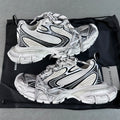 White Balenciaga-style chunky sneakers with black stripe details and lace-up uppers