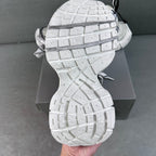 White sneaker soles with tread pattern, seen from the bottom and tied laces