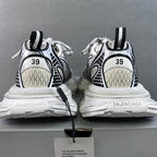 White sneakers with black heel loops and side stripes, showing back and soles
