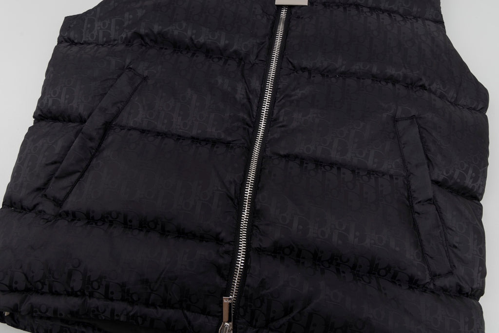 Black hooded puffer vest fabric and front zipper close-up
