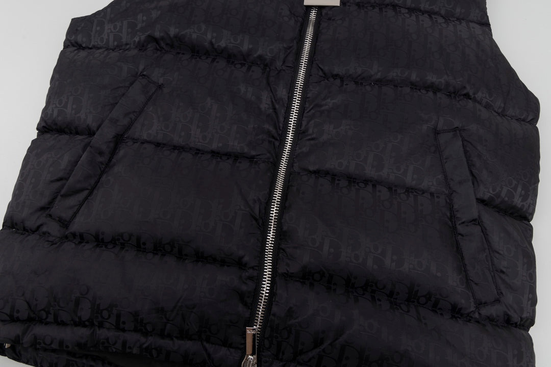 Black hooded puffer vest fabric and front zipper close-up