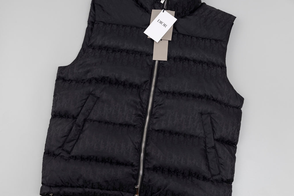 Black hooded puffer vest front, zipper and padded quilting detail