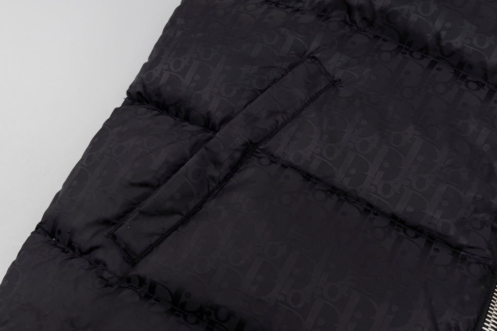 Black hooded puffer vest back panel with structured quilting