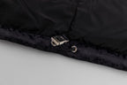 Black hooded puffer vest hem with snap closure and metal hardware