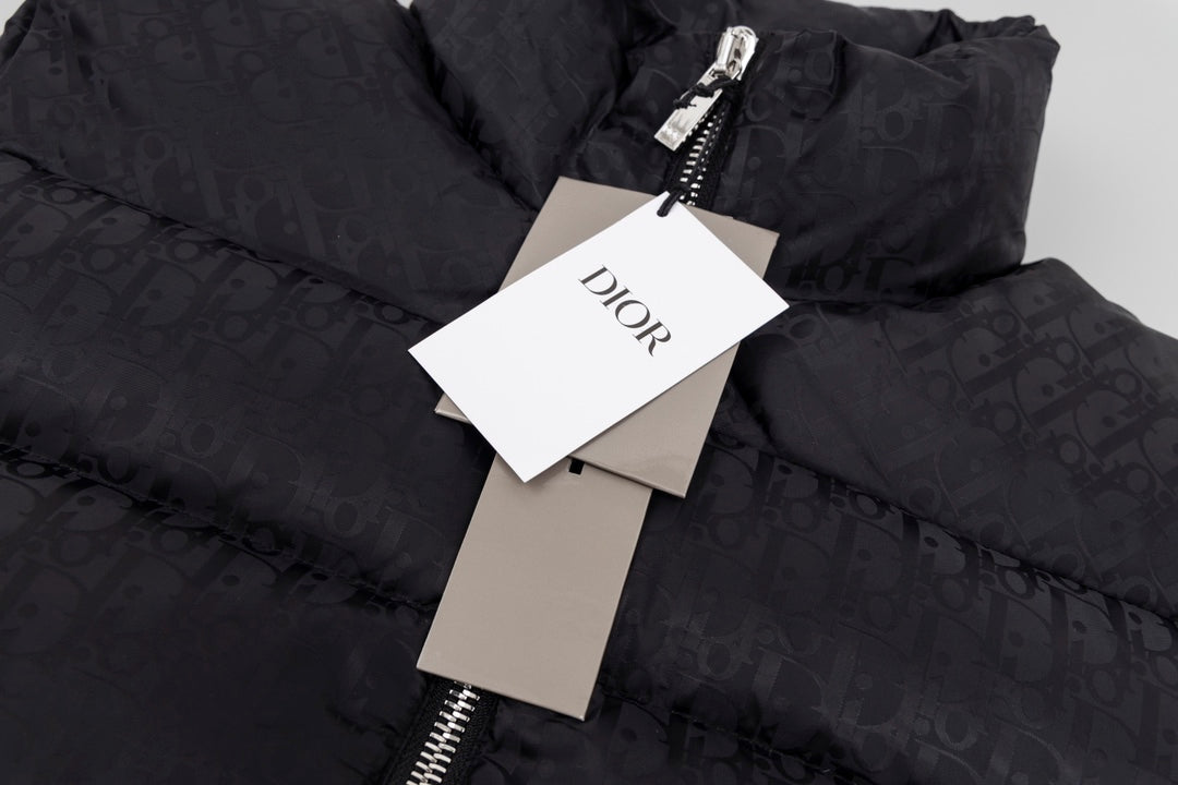 Black hooded puffer vest with attached Dior tags and zipper