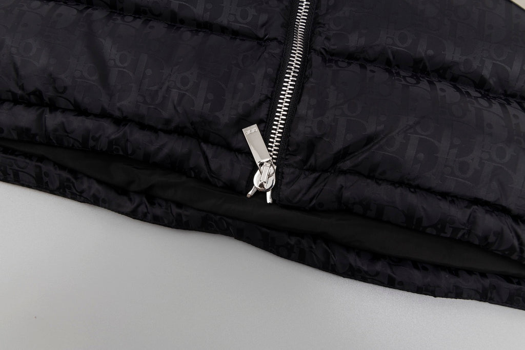 Black hooded puffer vest hem with zipper pull and metal ring