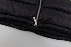 Black hooded puffer vest hem with zipper pull and metal ring