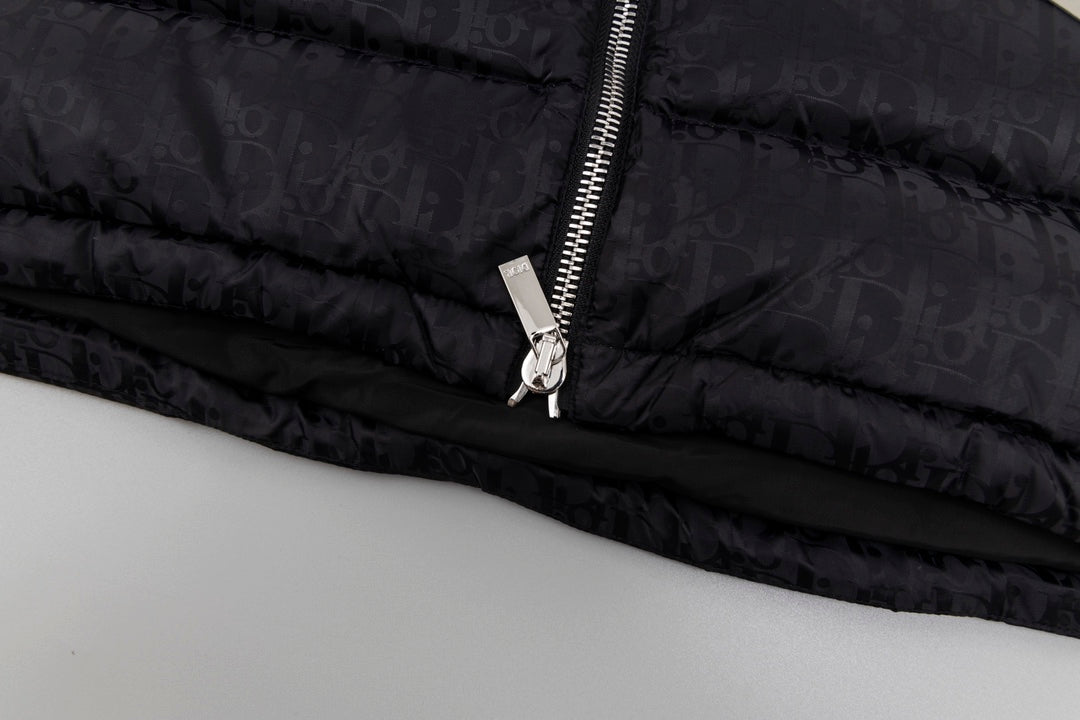 Black hooded puffer vest hem with zipper pull and metal ring