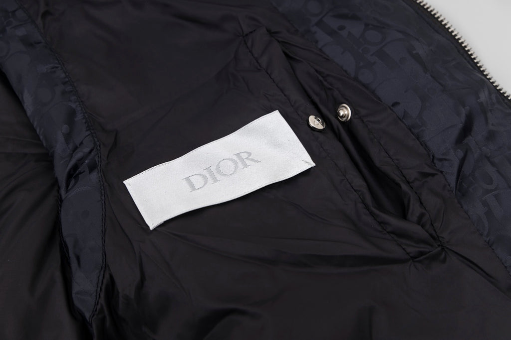 Black hooded puffer vest interior label and snap button detail