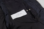 Black hooded puffer vest interior label and snap button detail