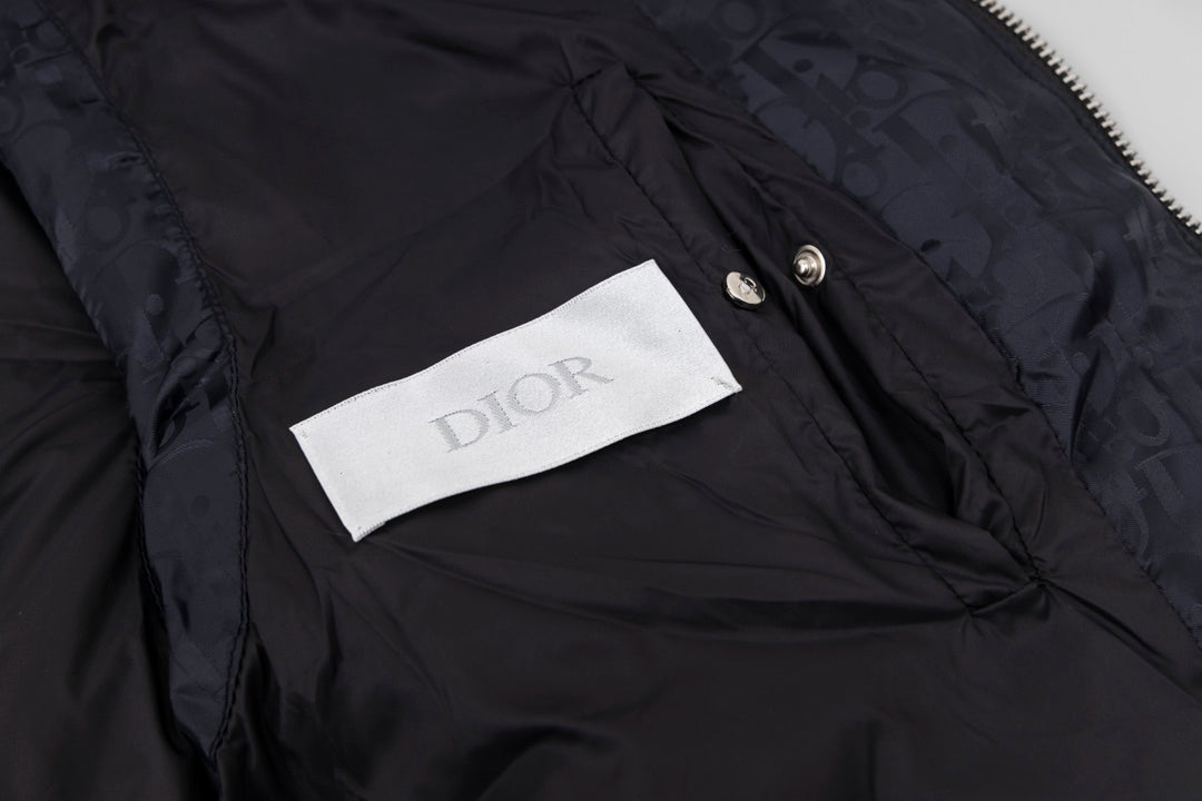 Black hooded puffer vest interior label and snap button detail
