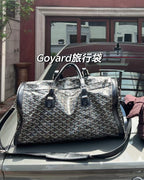Patterned duffel bag with black leather handles, dual top zippers, shoulder strap