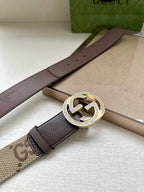 Gucci belt laid flat with brown leather strap and embellished circular G buckle
