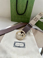 Gucci belt with dark brown leather strap and large circular G buckle