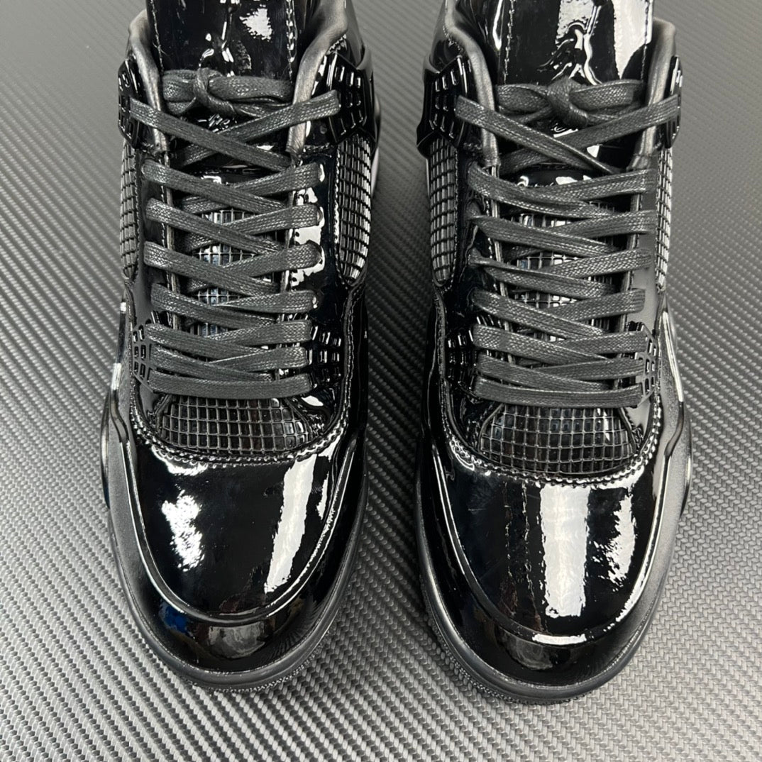Air Jordan 4 front view with black laces and mesh toe and quarter panels.