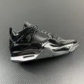 Black Air Jordan 4 sneaker, patent leather panels, mesh detail, lace-up.