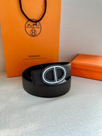 Black leather belt with silver double-H buckle, lying flat
