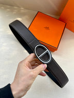 Black leather belt with textured strap and silver double-H buckle