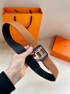 Tan leather belt with silver H buckle, shown with dark lining