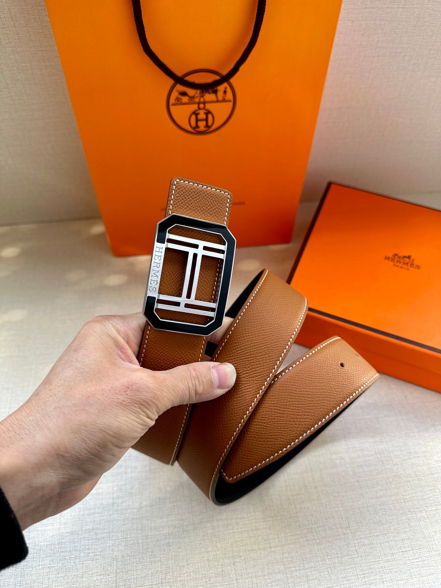 Tan leather belt with silver-tone square H buckle and second belt strap