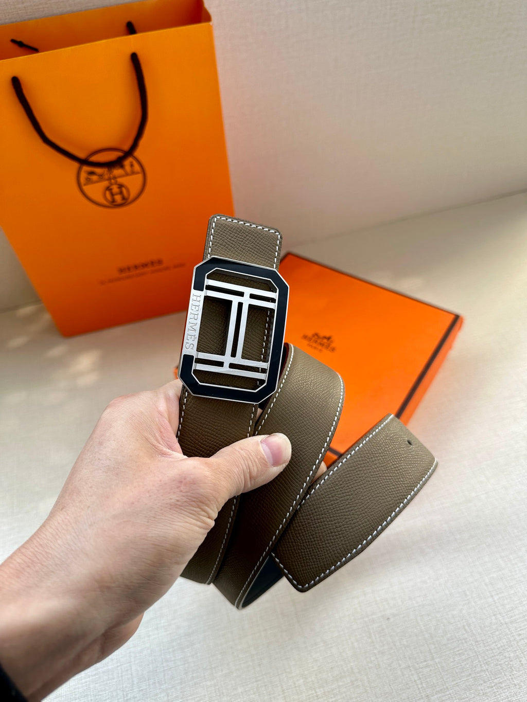 Dark gray leather belt with silver Hermes buckle and stitched edge