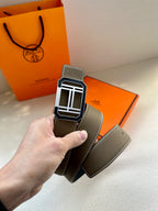 Dark gray leather belt with silver Hermes buckle and stitched edge