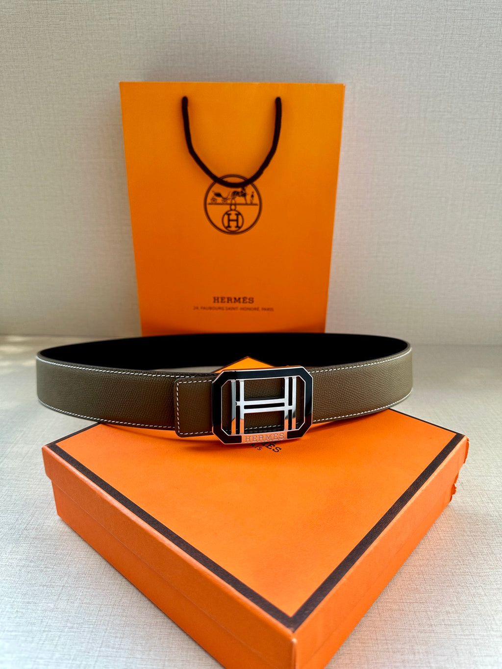 Dark gray leather belt with silver Hermes buckle, full front view