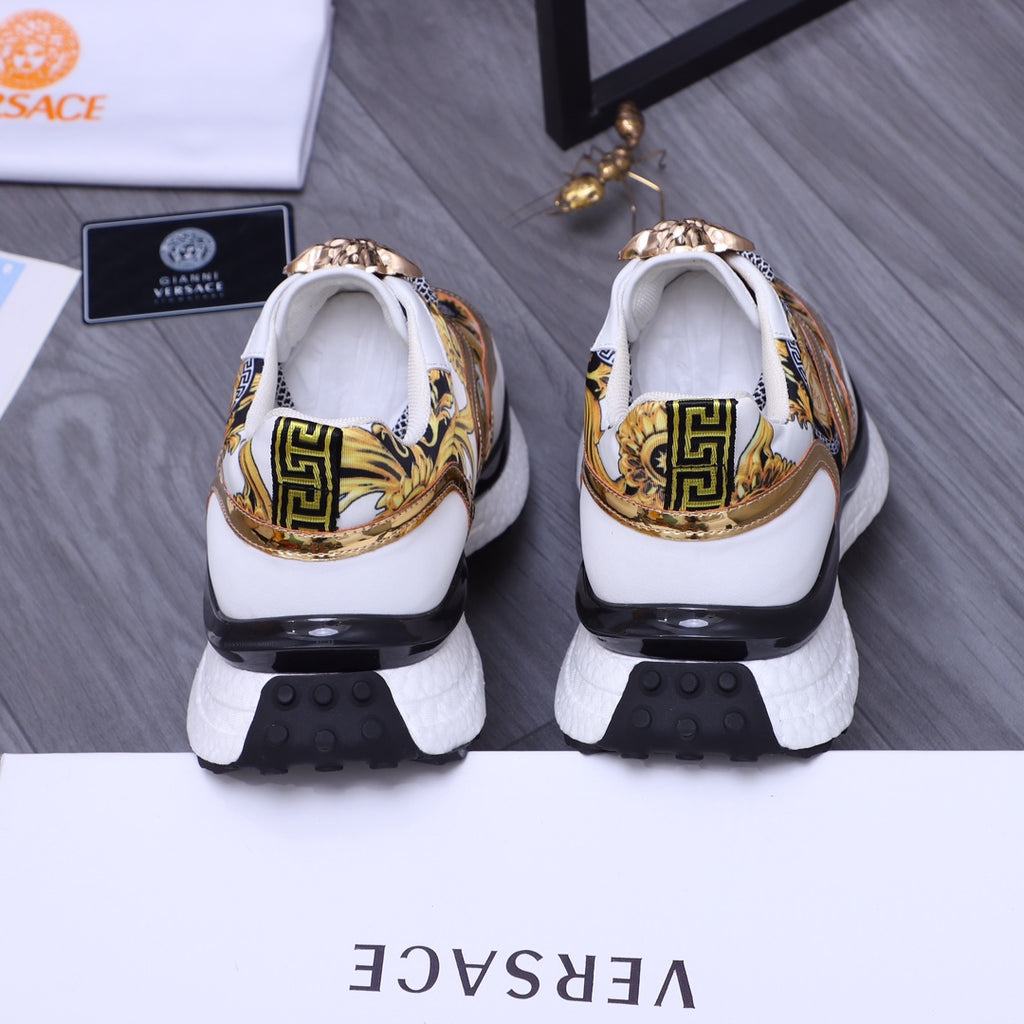 Versace luxury sneakers heel view, gold-and-blue print, white back and black tread soles