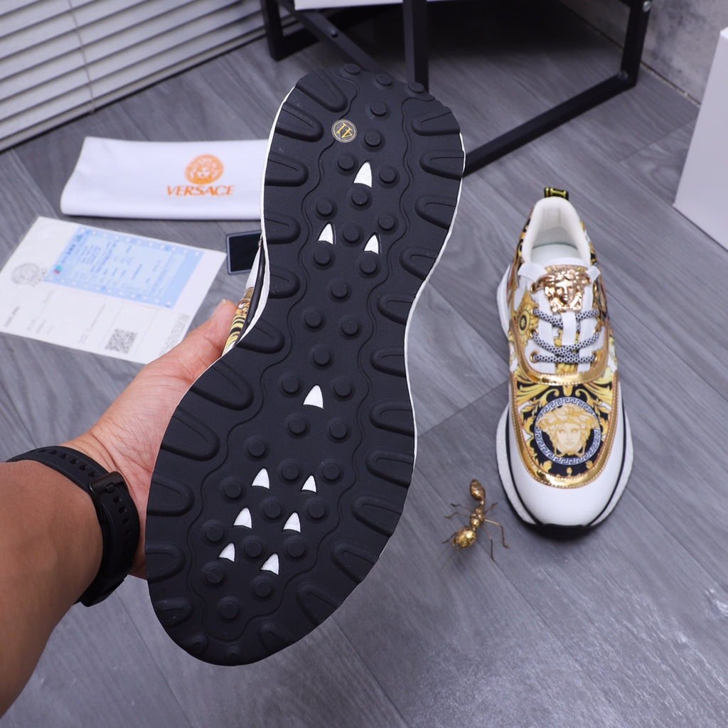 Versace luxury sneakers outsole view, textured black tread and white-and-gold upper