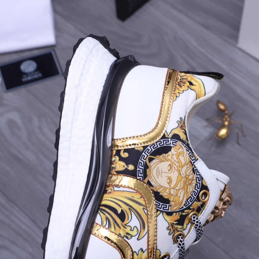Versace luxury sneakers side view, white panels with gold trim and blue patterned section