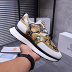 Versace luxury sneakers, baroque face graphic on blue-and-gold upper, white rubber sole
