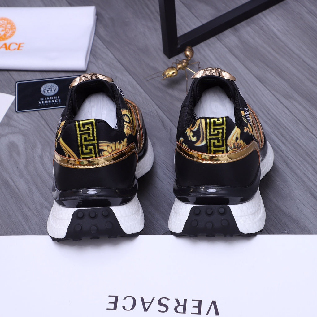 Versace luxury shoes, heel view black sneakers with gold crest detailing and white rubber outsole