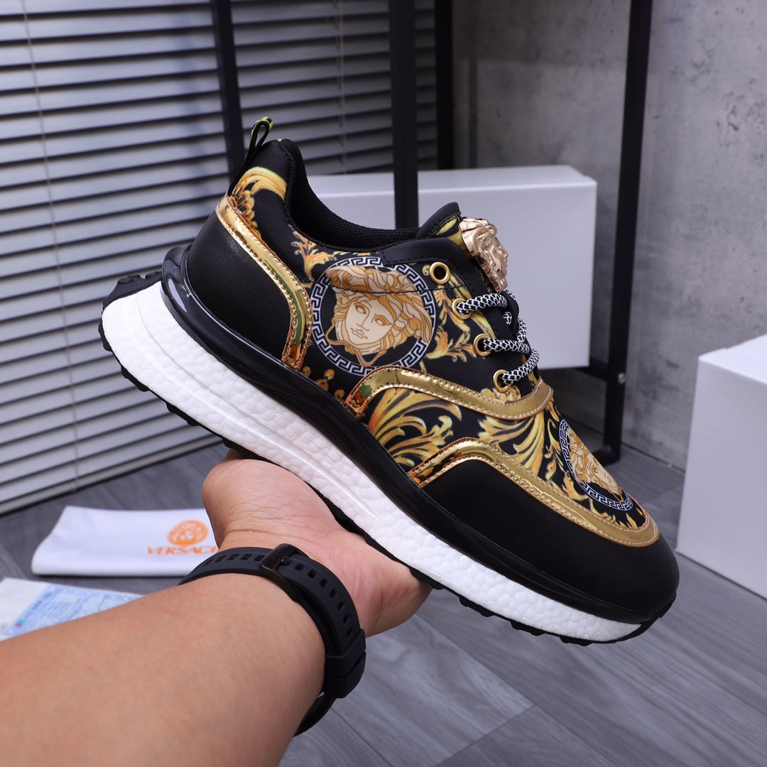 Versace luxury shoes, side profile black sneakers with gold Medusa motif and white cushioned sole