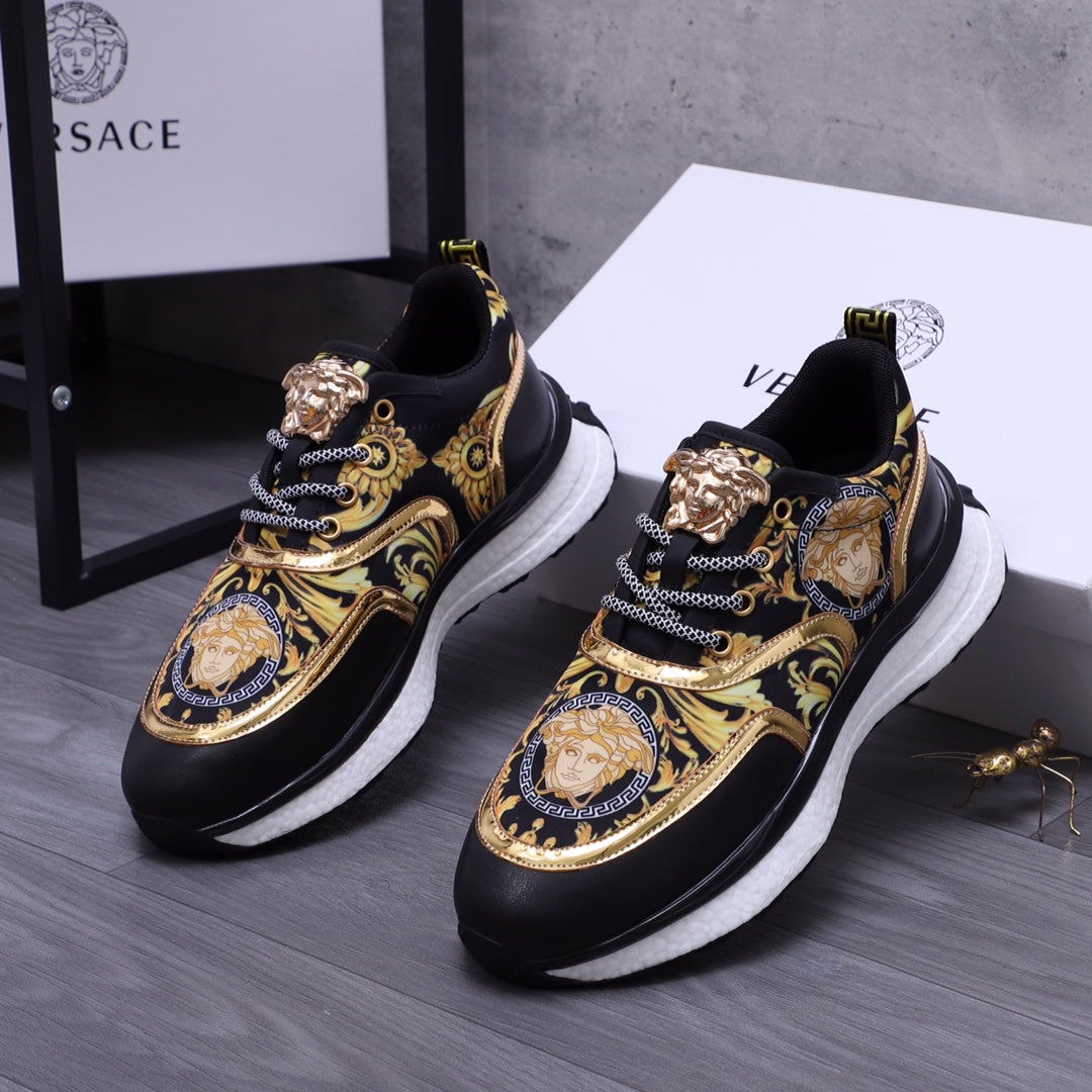 Versace luxury shoes, pair of black sneakers with gold baroque design, chain detailing, white soles