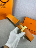 Two-tone leather belt with textured orange strap and light silver H buckle