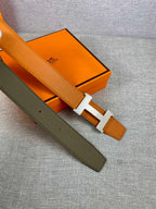 Two-tone leather belt with orange and olive straps and H buckle, side-by-side