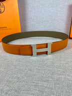 Orange leather belt with wide H buckle and textured finish