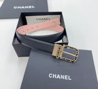 Chanel belt shown in gift box: dark strap with gold buckle and chain, pink inside lining.