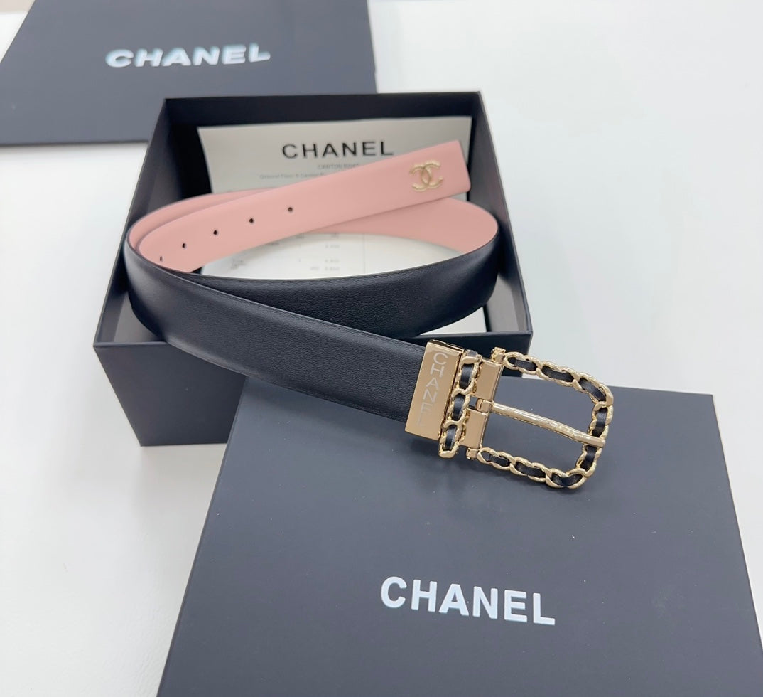 Chanel belt shown in gift box: dark strap with gold buckle and chain, pink inside lining.