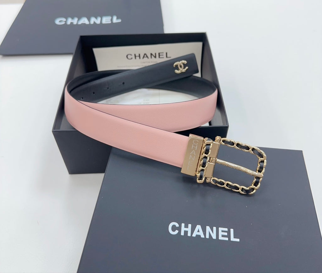 Chanel belt with dark leather outer and pink inner strap, gold buckle with chain detail.