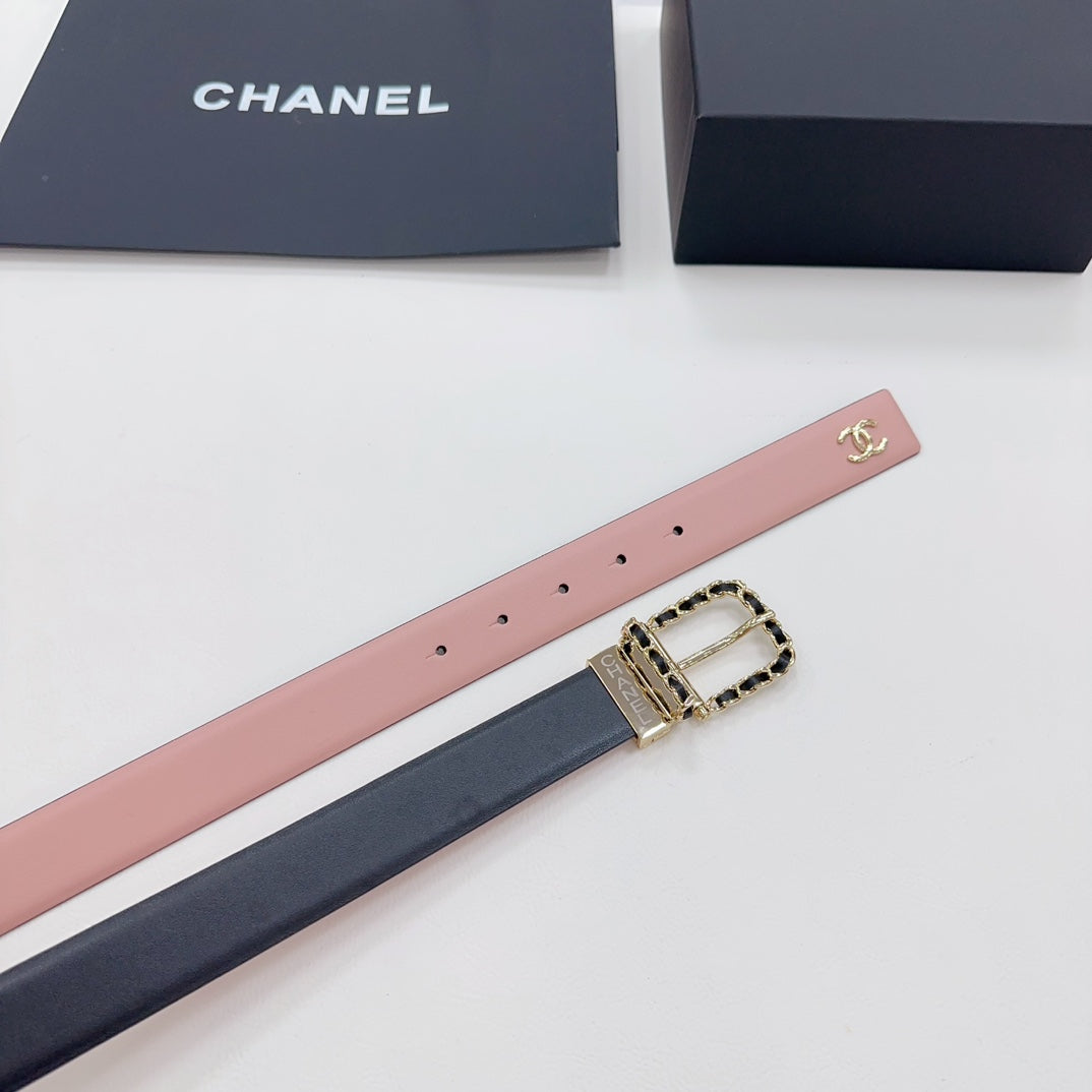Chanel belt close-up: pink strap with perforations and gold buckle with chain-link detail.