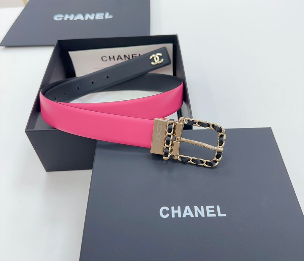 Chanel belt, navy exterior with bright hot-pink inner strap and gold-tone chain buckle.