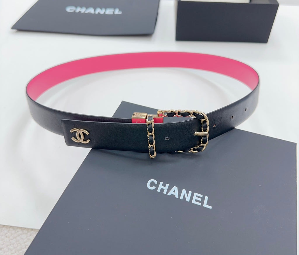 Chanel belt on display: navy leather with hot-pink underside and gold-tone clasp buckle.