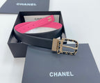 Chanel belt with navy leather and hot-pink lining, gold-tone buckle with chain links.