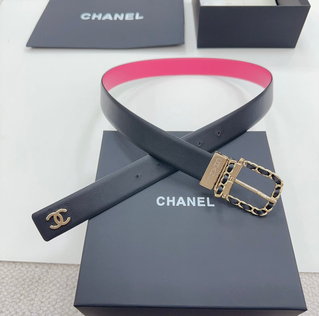 Chanel belt viewed crosswise: navy strap with hot-pink edge, gold-tone buckle.