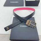 Chanel belt viewed crosswise: navy strap with hot-pink edge, gold-tone buckle.