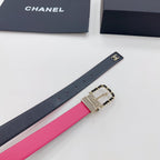 Chanel belt close-up showing navy strap with CC logo, pink underside, and gold buckle.