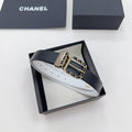 Chanel leather belt in dark blue with gold-tone CC buckle and chain detail