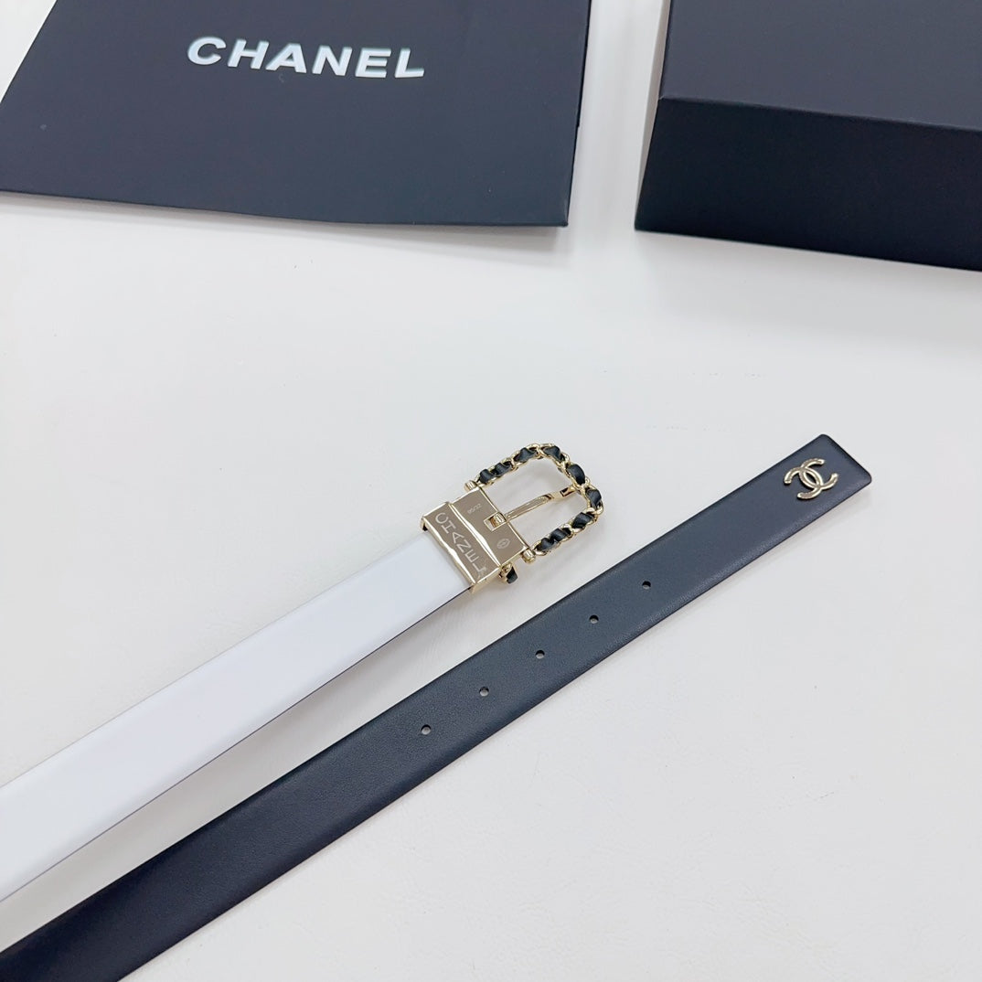 Leather belt laid flat with dark blue strap and gold-tone CC buckle with chain detail