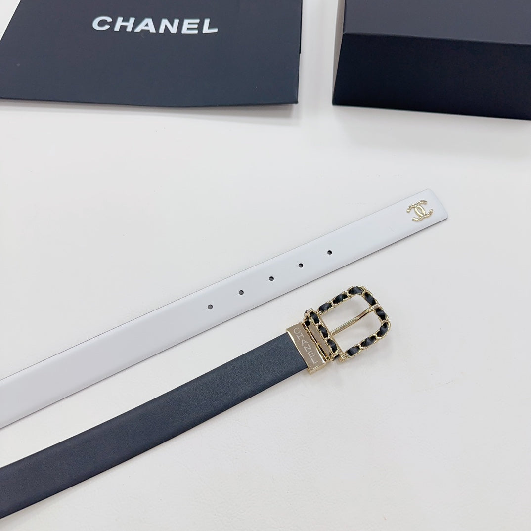 Leather belt laid flat with white strap and gold-tone CC buckle with chain detail